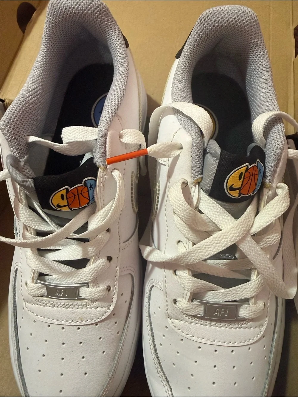 Nike Kids White Leather Sneakers with Blue Outsole and Graphic Accents